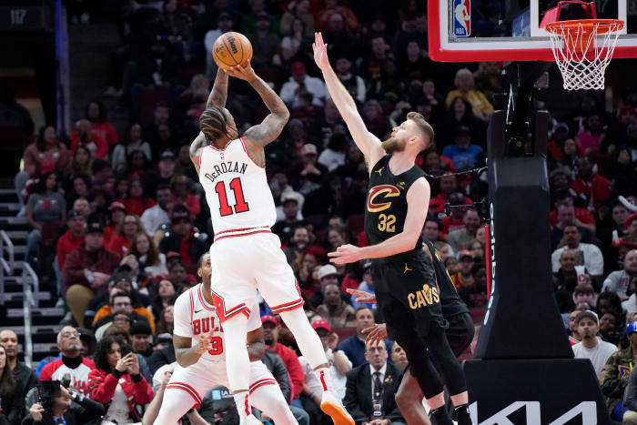 Feb 28, 2024; Chicago, Illinois, USA; Cleveland Cavaliers forward Dean Wade (32) defends Chicago Bulls forward DeMar DeRozan (11) during the second half at United Center. Mandatory Credit: David Banks-USA TODAY Sports